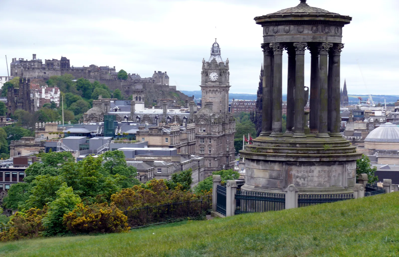 View from Calton Hill with the Dugald Stewart Monument in the foreground and Edinburgh Castle visible across the skyline