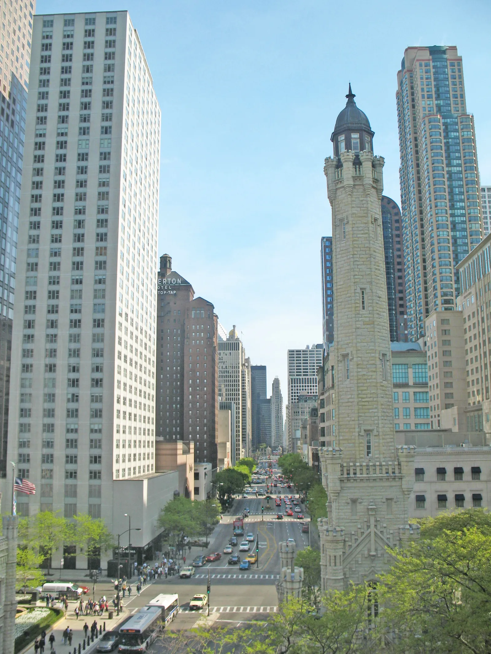 An elevated summer view down North Michigan Avenue, with the historic Water Tower, tree-lined sidewalks, and skyscrapers on both sides