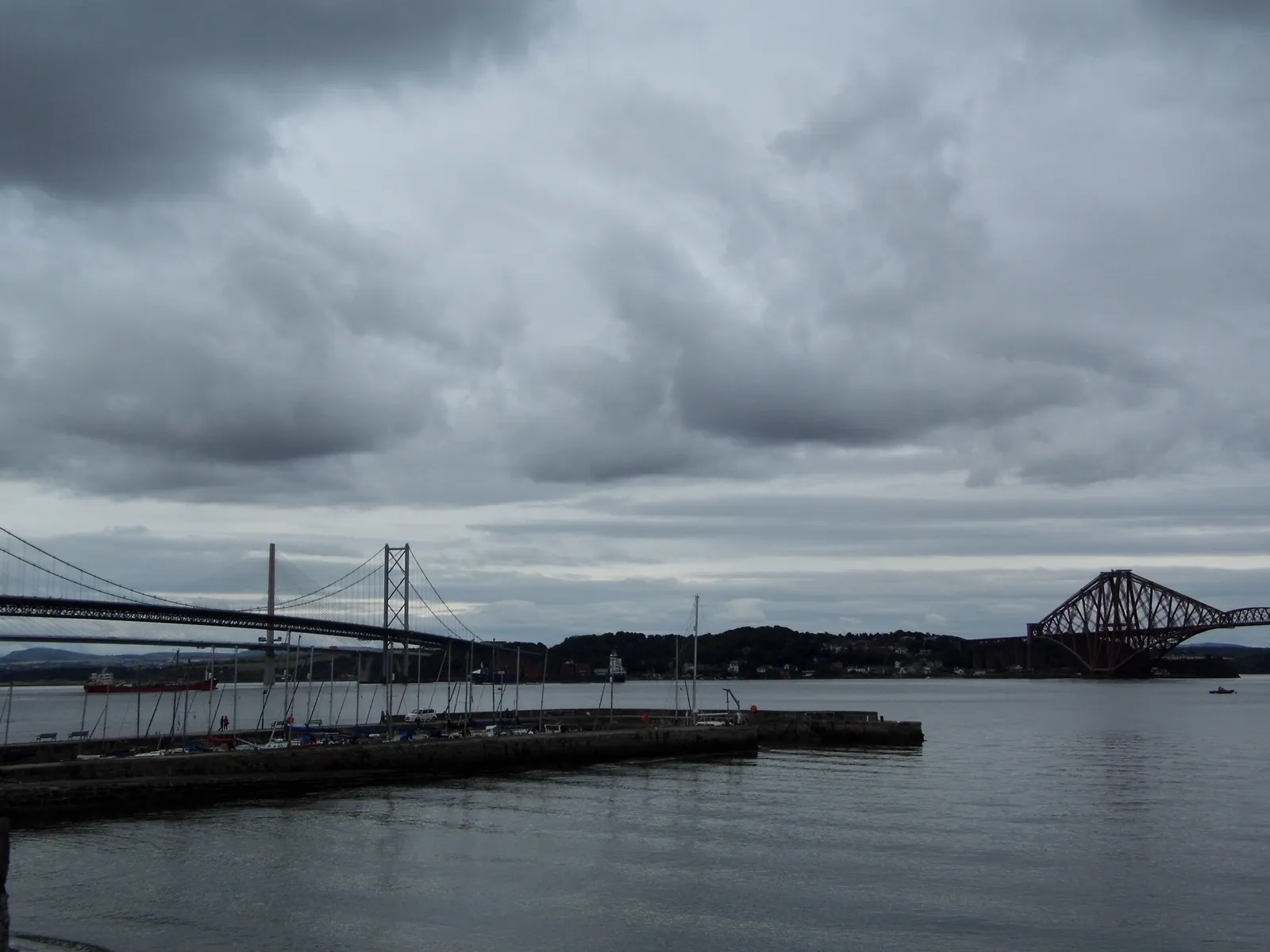 The Forth Road Bridge and the red Forth Rail Bridge seen together from South Queensferry's pier