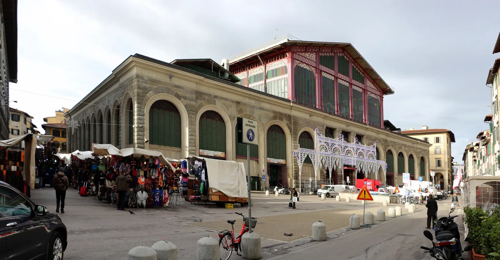 The Mercato Centrale market hall in Florence with San Lorenzo street stalls set up along its exterior arcade
