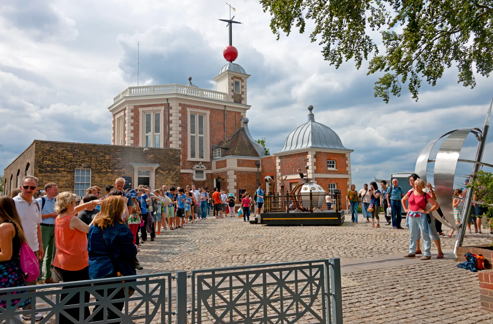 Visitors photographing the Prime Meridian line marker outside the Royal Observatory Greenwich
