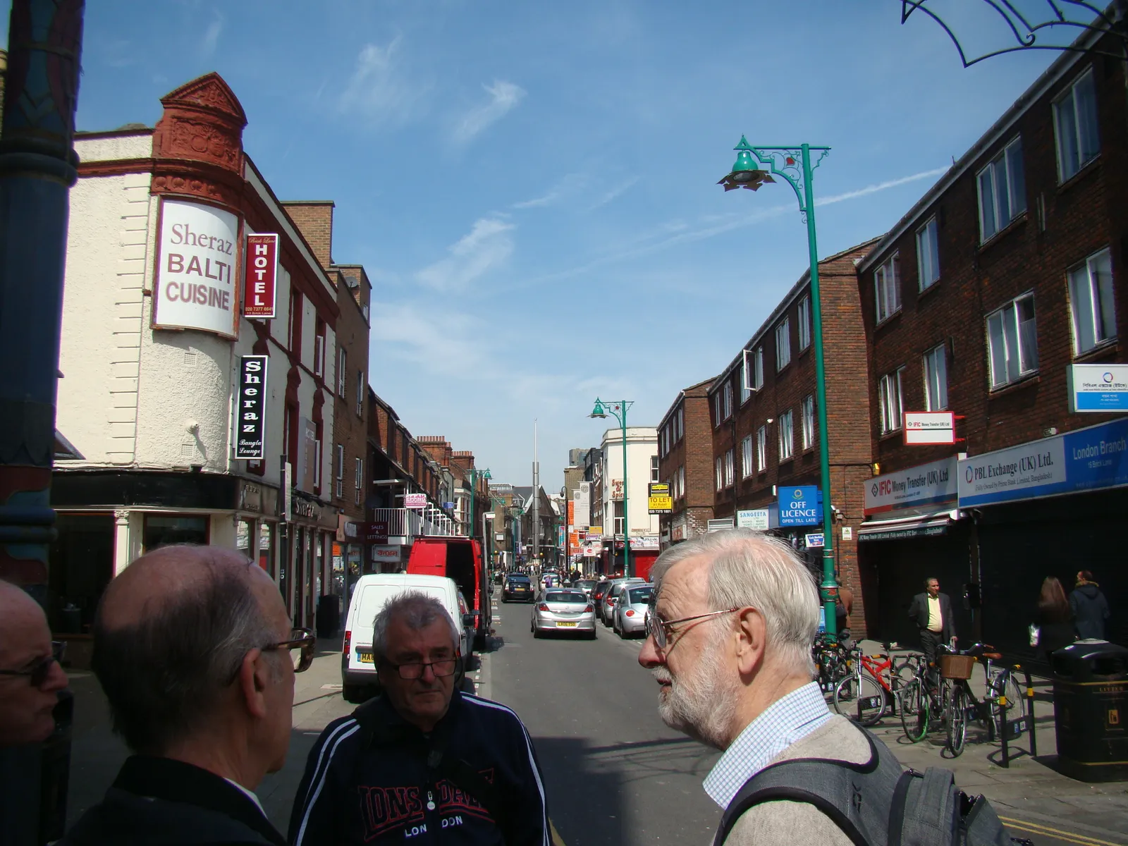 Brick Lane's strip of curry houses and shopfronts on a sunny afternoon