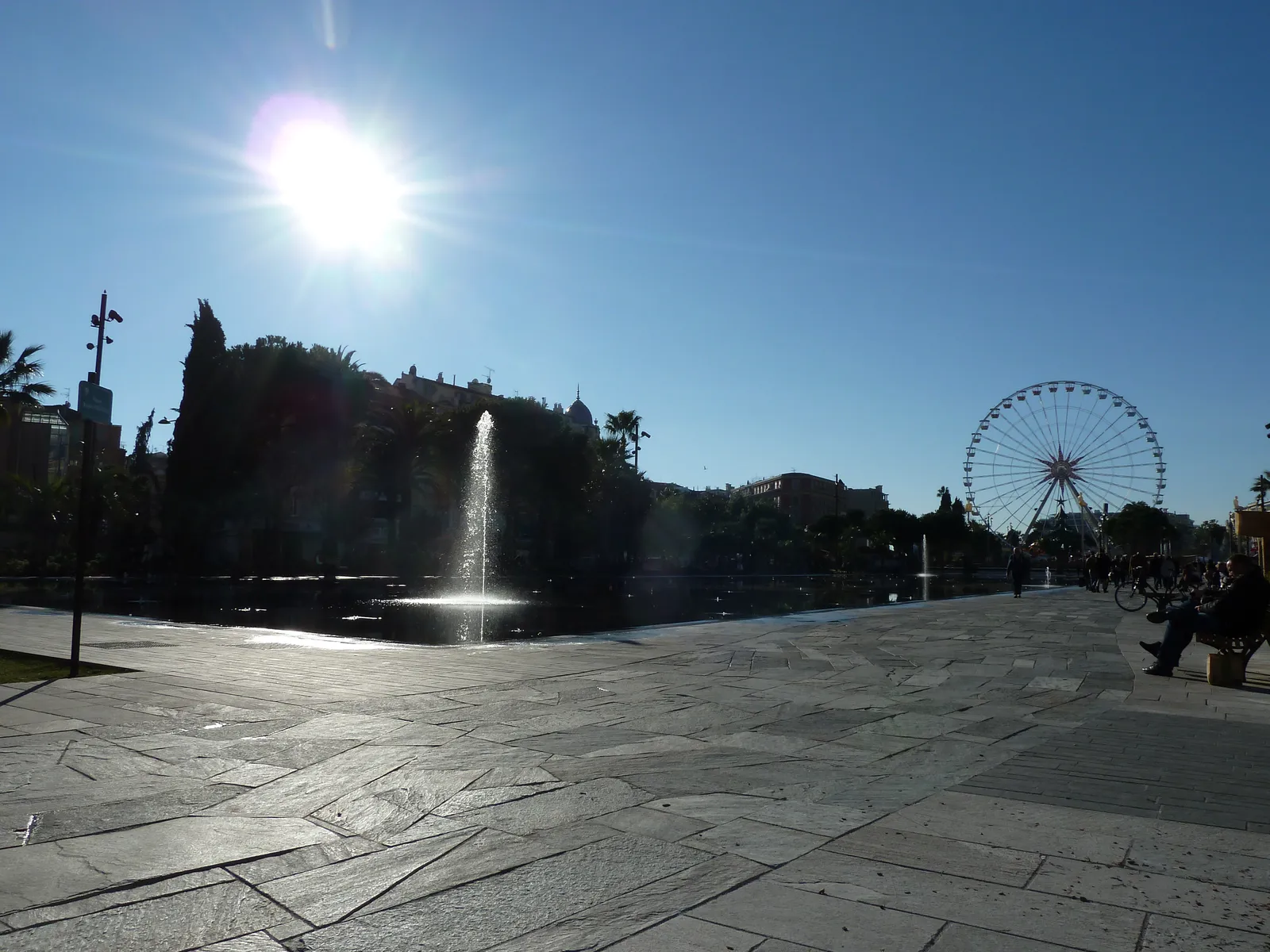 Fountain jets and a Ferris wheel in the Promenade du Paillon gardens in Nice