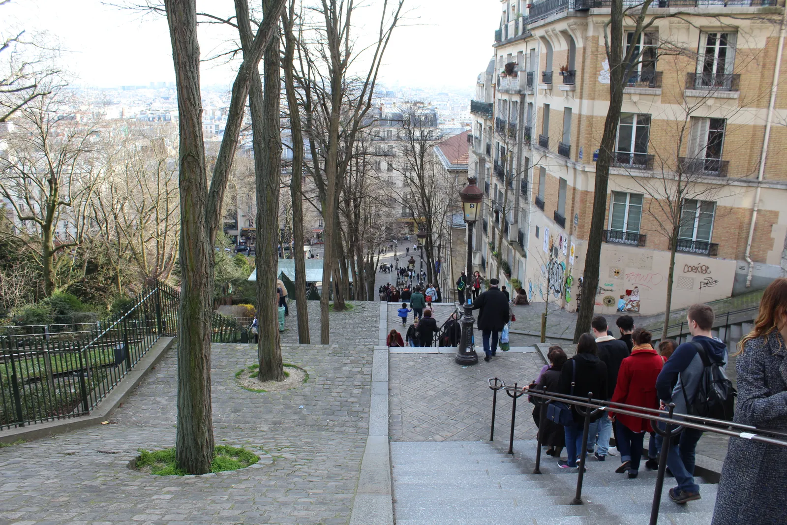 The stepped Rue Foyatier staircase descending the Montmartre hillside, lined with a lamppost and apartment buildings